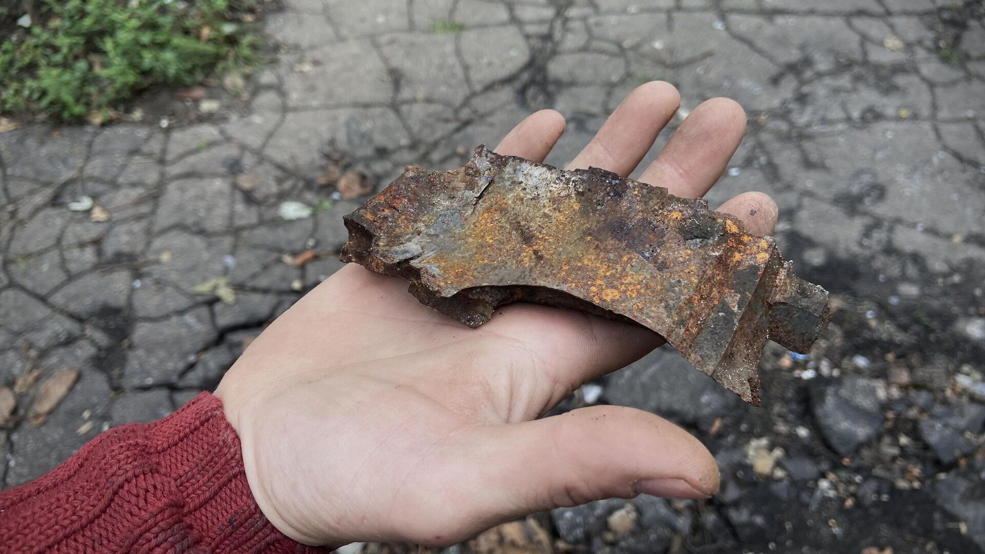 Мужчина демонстрирует осколок от снаряда